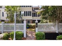 Charming two-story home with a white picket fence, brick path and manicured landscaping at 1969 Governors Landing Rd. # 224, Murrells Inlet, SC 29576