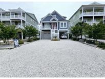 Beautiful raised beach home with hardi-plank siding and white stone driveway at 253 W Second Ave. S, Ocean Isle Beach, NC 28469
