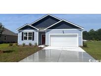 Charming single-story home featuring a two-car garage, a well-manicured lawn, and classic blue accents at 905 Farmers Passage Loop, Loris, SC 29569