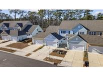 Aerial view of townhouses with attached garages and landscaping at 2523 Blue Crane Circle # 102, Myrtle Beach, SC 29577