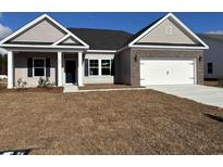 Charming single-story home featuring tan siding, brick accents, and a two-car garage at 323 Palmetto Sand Loop, Conway, SC 29527