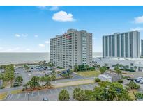 Coastal condo building with an ocean view, featuring a parking lot and easy access to the beach at 9820 Queensway Blvd. # 1501, Myrtle Beach, SC 29572