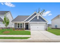 Charming single-story home with gray siding, stone accents, well-manicured lawn, and a two-car garage at 2412 Campton Loop, Conway, SC 29527