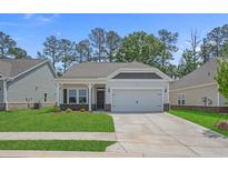 Charming single-story home with a well-manicured lawn and attached two-car garage on a sunny day at 2441 Campton Loop, Conway, SC 29527