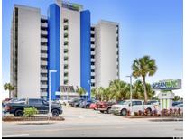 Ocean Park Resort exterior view featuring parking, palm trees, and a blue and white building at 1905 S Ocean Blvd. # 922-924, Myrtle Beach, SC 29577