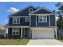 Charming two-story home with a blue shingle exterior, white trim, black shutters and an attached two-car garage at 694 Choctaw Dr., Conway, SC 29526