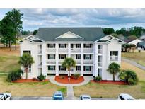 Attractive three-story building with balconies and palm trees at 697 Tupelo Ln. # 24G, Longs, SC 29568