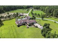 Expansive property featuring a pool, mature trees, and a large home with a long driveway at 1692 S Morgan Ave., Andrews, SC 29510