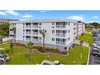 Multi-story condo building featuring balconies, well-maintained landscaping, and ample parking at 191 Maison Dr. # B203, Myrtle Beach, SC 29572
