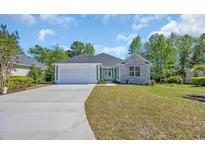 Charming single-story home featuring a stone facade and a two-car garage at 2515 Saint Andrews Dr., Little River, SC 29566