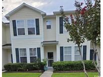 Charming townhome showcasing a manicured lawn and complementary landscaping at 109 Olde Towne Way # 4, Myrtle Beach, SC 29588