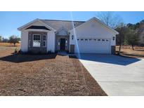 Charming single-story home featuring a classic design, attached garage, and well-manicured front lawn at 2770 Daisy Rd., Loris, SC 29569