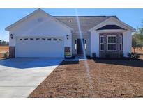Charming single-story home with a two-car garage and landscaped front yard at 2778 Daisy Rd., Loris, SC 29569