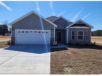 Charming single-story home featuring a two-car garage and tasteful brick and siding details at 2808 Daisy Rd., Loris, SC 29569