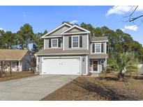 Charming two-story home with a gray exterior, attached garage, and well-maintained front yard at 4708 Caryle Ct., Myrtle Beach, SC 29579