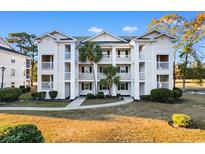 Inviting 3-story building with ample parking and landscaping at 597 Blue River Ct. # 2F, Myrtle Beach, SC 29579