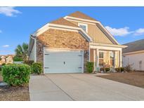 Charming home with a two-car garage, stone accents, manicured bushes and beautiful curb appeal at 962 Witherbee Way, Little River, SC 29566