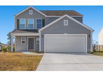 Charming two-story home featuring a two-car garage and well-maintained front yard on a sunny day at 2053 Haystack Way, Myrtle Beach, SC 29579