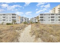 Beachfront property with boardwalk path leading to the sandy shore at 2405 S Ocean Blvd. # 207, North Myrtle Beach, SC 29582