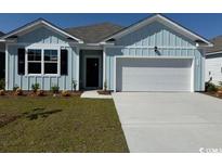 Charming single-story home featuring a blue exterior, attached garage, and well-manicured lawn at 556 Duvall St., Longs, SC 29568