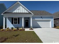 Charming single-story home with light blue siding, well-manicured lawn, and attached two-car garage at 564 Duvall St., Longs, SC 29568