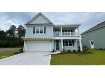 Charming two-story home featuring a welcoming front porch and attached garage at 6056 Forest Dell Ct, Myrtle Beach, SC 29579