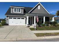 Charming home featuring a two-car garage, gray siding, and a welcoming front porch at 914 Mary Read Dr., North Myrtle Beach, SC 29582