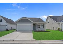 Charming single-story home featuring a two-car garage, well-manicured lawn, and lovely curb appeal at 1200 Nw Calabash Station Blvd., Calabash, NC 28467