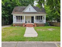 Charming white one-story home with front porch, landscaped yard, and inviting curb appeal at 306 E Godbold St., Marion, SC 29571