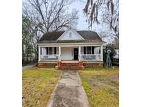Charming cottage-style home featuring a welcoming front porch and classic architectural details at 306 E Godbold St., Marion, SC 29571