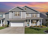 Charming two-story home with gray siding, manicured lawn and a two car garage at 8044 Fort Hill Way, Myrtle Beach, SC 29579