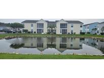 Lovely condo community with pond and manicured landscaping reflecting in the water at 8830 Chandler Dr. # E, Myrtle Beach, SC 29575