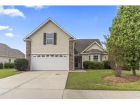Charming home featuring a well-manicured lawn and a two-car garage at 1133 Spalding Ct., Surfside Beach, SC 29575