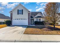 Charming two-story home featuring a well-manicured lawn and a two-car garage at 1133 Spalding Ct., Surfside Beach, SC 29575