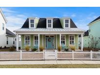 Charming home featuring a cozy front porch with rocking chairs and a beautifully landscaped yard at 3126 White Jasmine Dr., Little River, SC 29566
