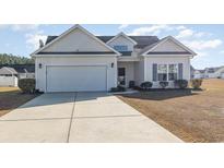 Craftsman style home with attached garage and manicured lawn at 604 Mcclain Ct., Conway, SC 29526