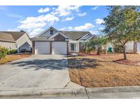 Charming single Gathering home featuring a two car garage and a well-manicured lawn at 784 Riverward Dr., Myrtle Beach, SC 29588