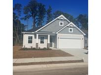 Charming single-Gathering home featuring a two-car garage, decorative shingles, and well-manicured front lawn at 1217 Nw Calabash Station Blvd., Calabash, NC 28467