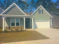 Charming one-story home features a two-car garage, landscaped front yard, and inviting front entrance at 1233 Nw Calabash Station Blvd., Calabash, NC 28467