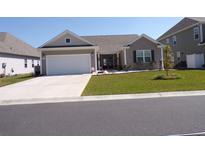 Charming single-Gathering home with a well-manicured lawn and a two-car garage at 3070 Sutherland Dr., Little River, SC 29566