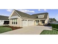 Charming home with a three-car garage, well-manicured lawn, and inviting light blue front door at 377 Starlit Way, Myrtle Beach, SC 29579