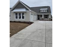 Charming single-Gathering home features a spacious three-car garage and manicured landscaping at 377 Starlit Way, Myrtle Beach, SC 29579