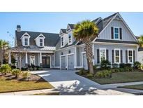 Beautiful two-story home with attached garage, lovely landscaping, and a welcoming front porch at 6105 Bolsena Place, Myrtle Beach, SC 29577