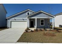 Charming single-Gathering home with a two-car garage, landscaped front yard and classic light-blue siding at 928 Laconic Dr., Myrtle Beach, SC 29588