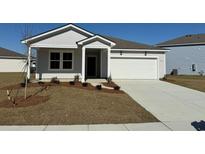 Charming single-story home featuring a two-car garage and well-maintained front lawn at 970 Laconic Dr., Myrtle Beach, SC 29588