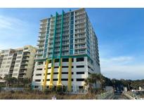 Exterior shot of a tall condo building with multiple floors, balconies, and parking at 2301 S Ocean Blvd. # 1002, North Myrtle Beach, SC 29582