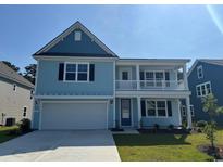 Charming two-story home featuring a welcoming front porch and a two-car garage at 547 Slaty Dr., Myrtle Beach, SC 29588