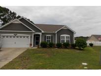 Charming single-story home with gray siding, well-maintained landscaping, and attached two-car garage at 741 Londonberry Ct., Conway, SC 29526