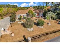 Charming home with a manicured front yard, brick mailbox, and mature landscaping at 5938 Rahnavard Blvd., Myrtle Beach, SC 29588