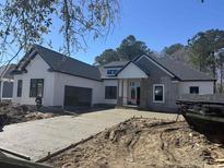 New construction home featuring a spacious driveway and an attached two-car garage at 1019 Muskeg Ct., Conway, SC 29526